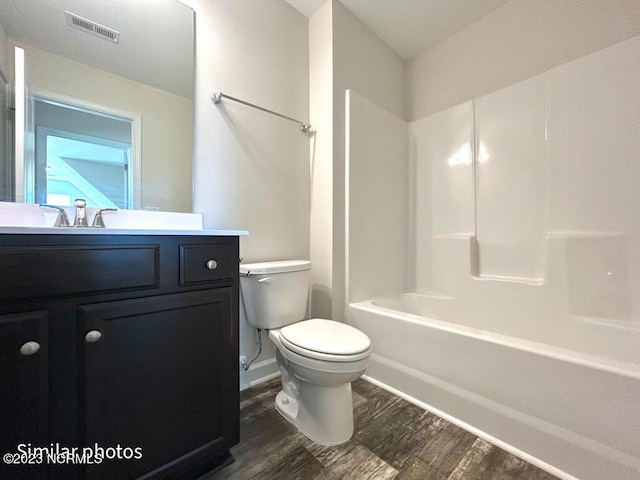 full bathroom with visible vents, vanity, toilet, and wood finished floors