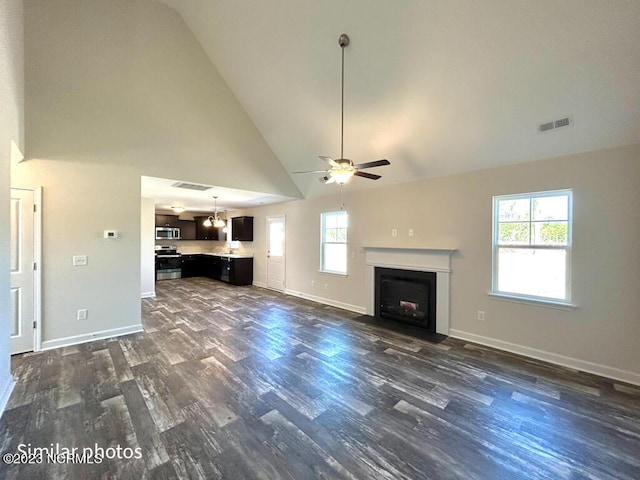 unfurnished living room with baseboards, a fireplace with flush hearth, visible vents, and dark wood-type flooring