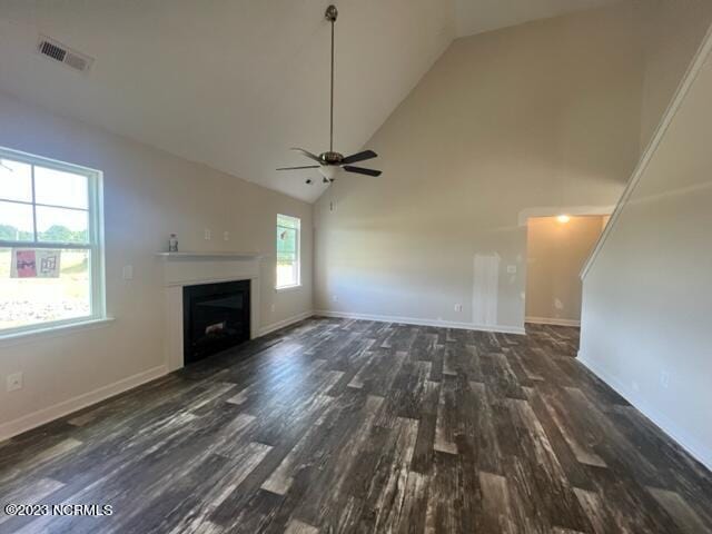 unfurnished living room featuring high vaulted ceiling, a fireplace, wood finished floors, visible vents, and baseboards