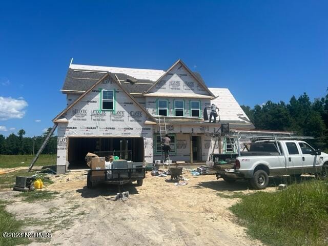 property in mid-construction with a garage and driveway