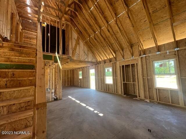 miscellaneous room with high vaulted ceiling