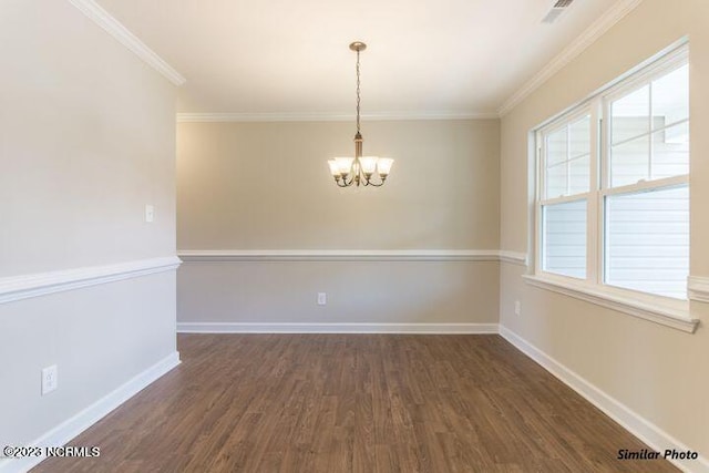 unfurnished room with a chandelier, dark wood-type flooring, baseboards, and crown molding