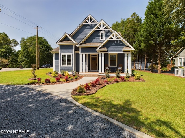 craftsman inspired home with a porch and a front lawn