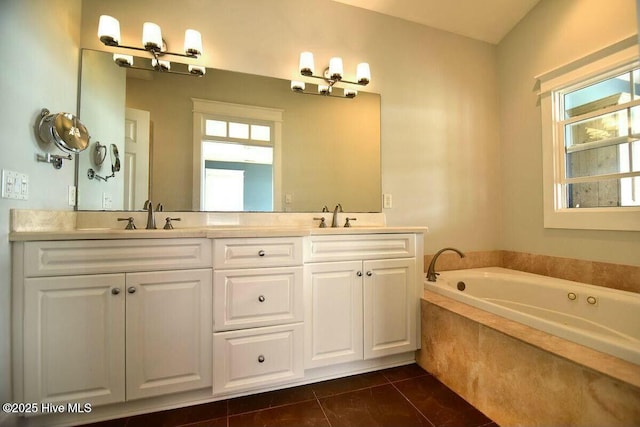 bathroom with double vanity, a garden tub, a sink, and tile patterned floors