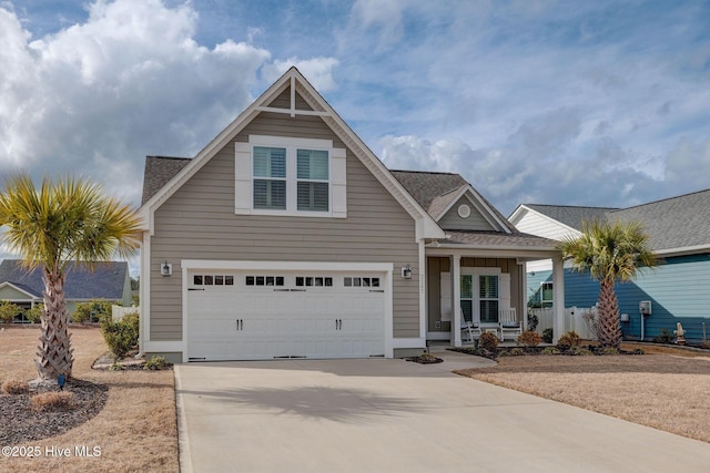 view of front of house featuring a garage, covered porch, roof with shingles, and concrete driveway