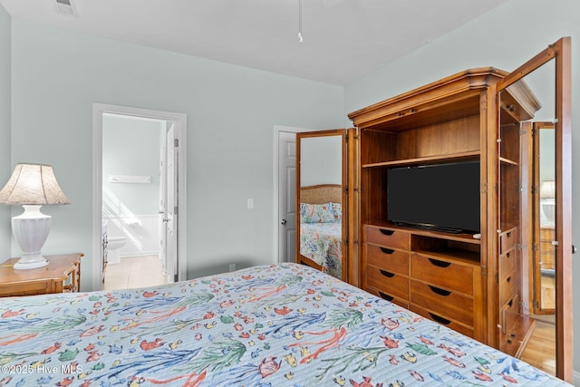 bedroom featuring visible vents and connected bathroom