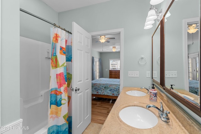 ensuite bathroom featuring a sink, double vanity, and connected bathroom