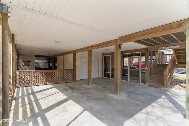 view of patio / terrace featuring driveway, stairs, and a carport