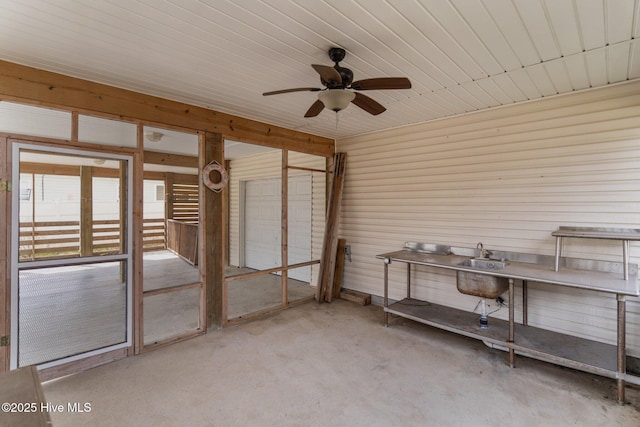 miscellaneous room featuring concrete flooring and ceiling fan