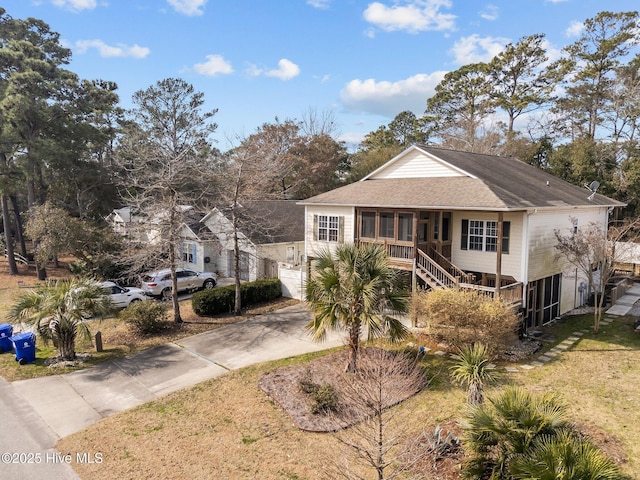 view of front of home with stairs and concrete driveway