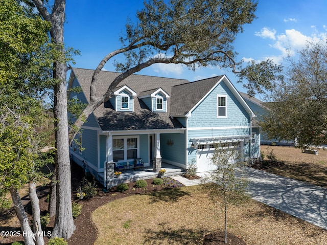 craftsman-style house with a porch, concrete driveway, an attached garage, and a shingled roof