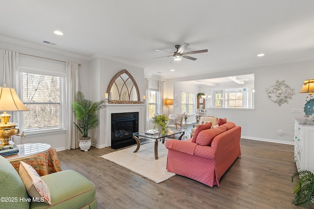 living room with ornamental molding, a ceiling fan, and wood finished floors