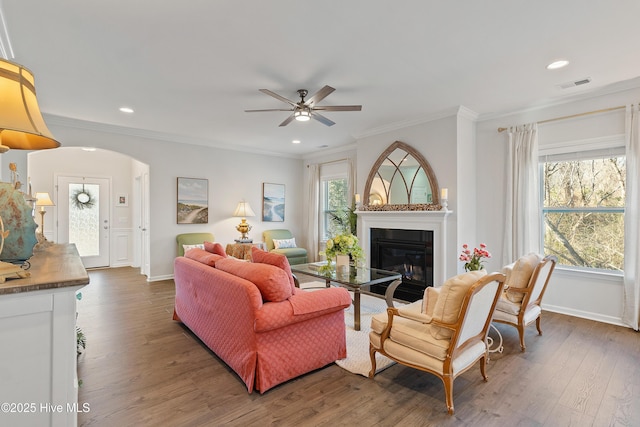 living room featuring visible vents, plenty of natural light, ceiling fan, and a glass covered fireplace