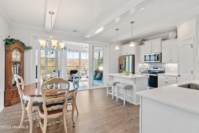 dining area featuring light wood finished floors, visible vents, crown molding, a chandelier, and beam ceiling