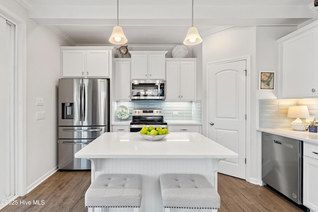 kitchen featuring white cabinetry, light countertops, backsplash, and appliances with stainless steel finishes