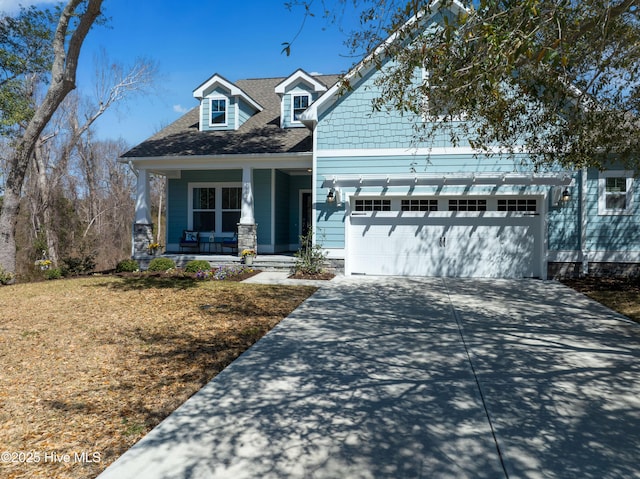 view of front of home featuring covered porch, concrete driveway, and an attached garage