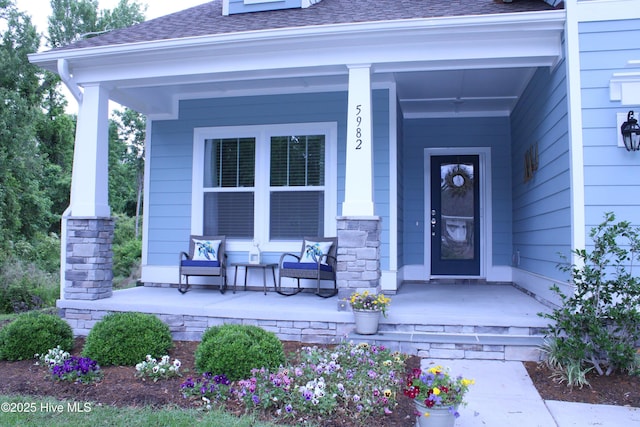 5982 Gray Squirrel Path, Southport, NC 28461 - property entrance featuring stone siding, a porch, and a shingled roof