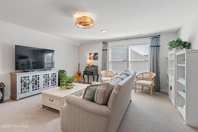 living area featuring visible vents, light colored carpet, baseboards, and vaulted ceiling