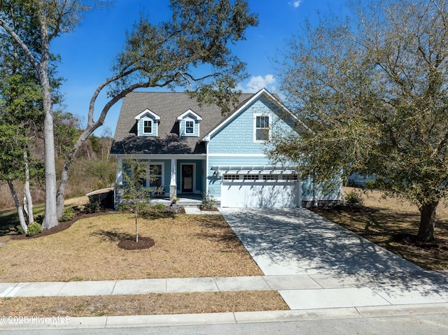 view of front of property with a front yard, driveway, roof with shingles, a porch, and a garage