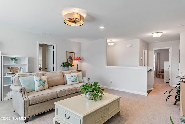 living area featuring visible vents, recessed lighting, light colored carpet, and baseboards