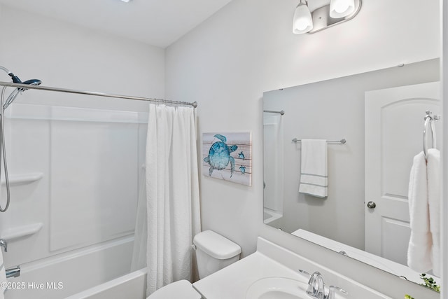 full bathroom with vanity, shower / tub combo, and toilet