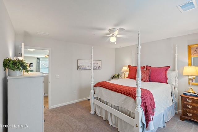 carpeted bedroom with visible vents, baseboards, and a ceiling fan