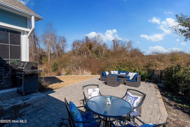 view of patio featuring outdoor dining area, a grill, outdoor lounge area, and fence