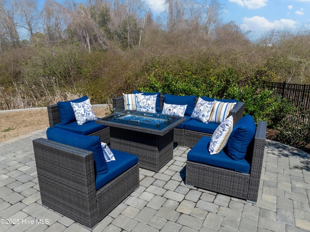 view of patio with an outdoor living space and fence