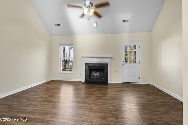 unfurnished living room featuring lofted ceiling, plenty of natural light, and visible vents