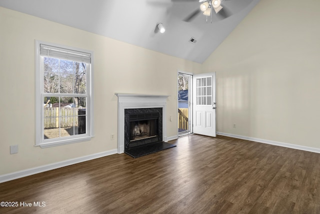 unfurnished living room featuring a ceiling fan, dark wood-style flooring, baseboards, and a premium fireplace