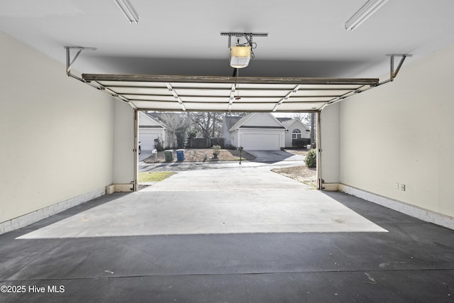 garage featuring baseboards and a garage door opener