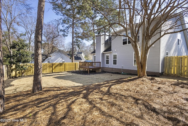 view of yard with a fenced backyard and a deck