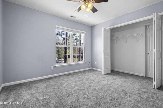 unfurnished bedroom featuring a closet, visible vents, carpet flooring, ceiling fan, and baseboards