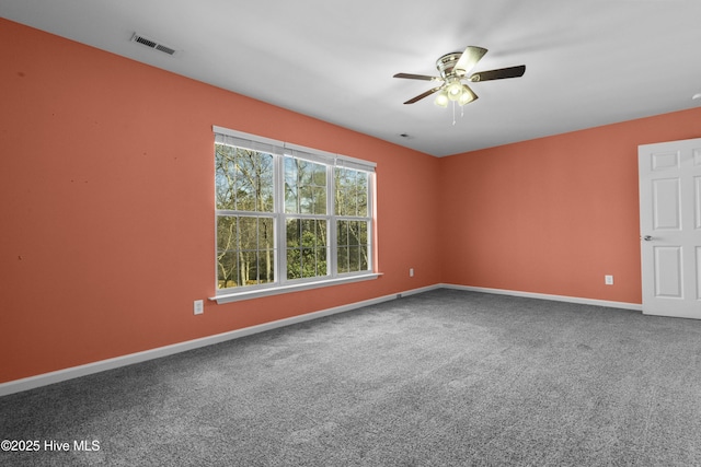 spare room with baseboards, visible vents, ceiling fan, and carpet flooring