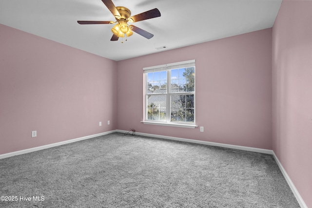 carpeted empty room with baseboards, visible vents, and a ceiling fan