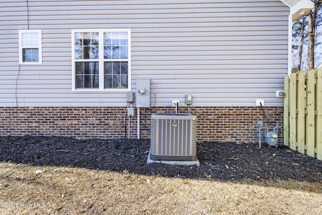 details featuring central AC unit and fence