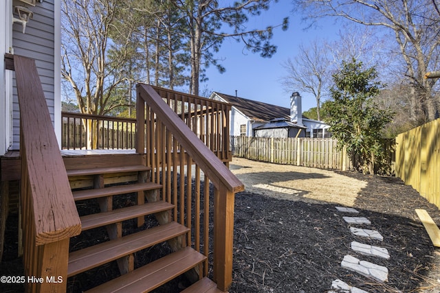 view of yard featuring a fenced backyard, stairway, and a wooden deck