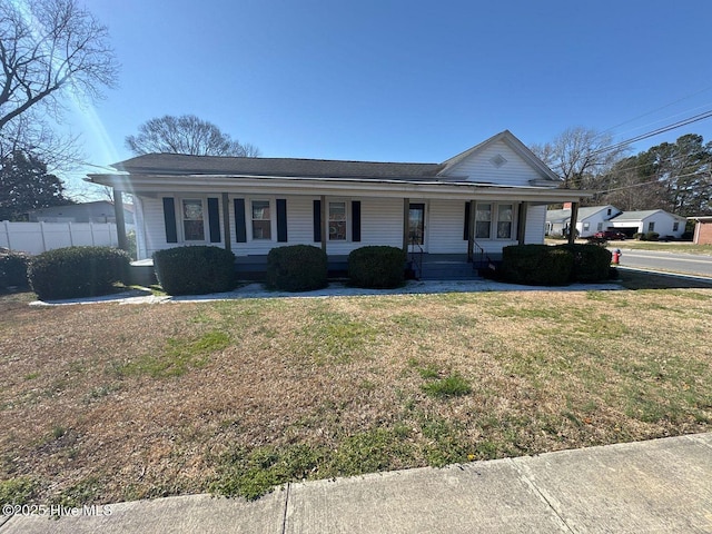 single story home featuring covered porch and a front lawn