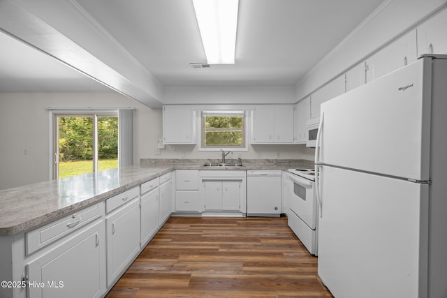 3610 Wedgewood Dr, Trent Woods, NC 28562 - kitchen featuring white appliances, a peninsula, a sink, white cabinetry, and dark wood-style flooring