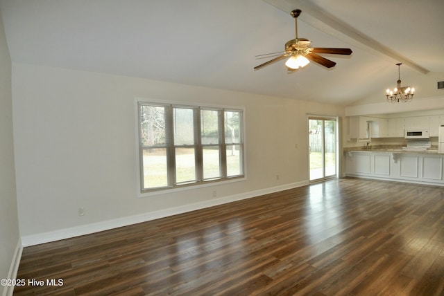 unfurnished living room featuring vaulted ceiling with beams, ceiling fan with notable chandelier, a sink, baseboards, and dark wood finished floors