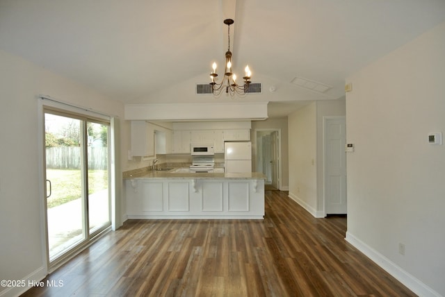 kitchen with white appliances, visible vents, a peninsula, light countertops, and a sink