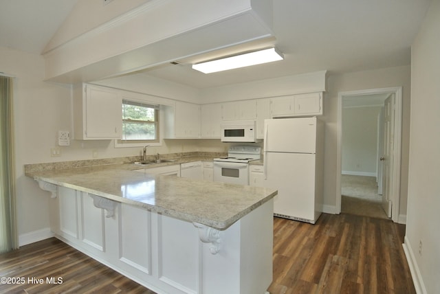 kitchen featuring white appliances, light countertops, a peninsula, and white cabinets