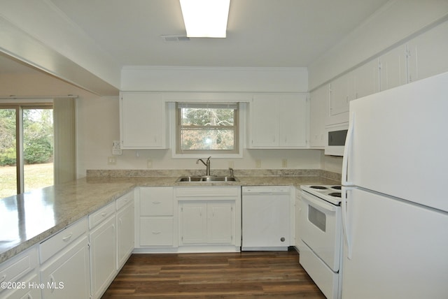 kitchen featuring dark wood-style floors, white cabinets, a sink, white appliances, and a peninsula