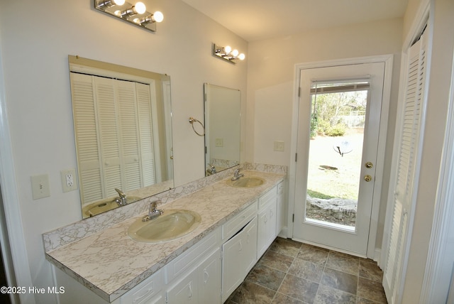 full bath featuring double vanity, a closet, and a sink