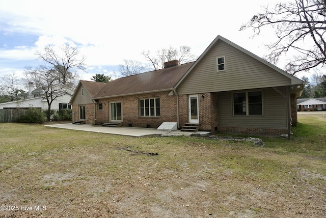 back of property featuring brick siding, a patio, a chimney, entry steps, and crawl space