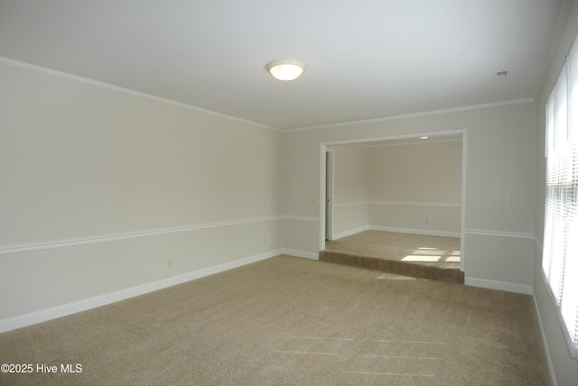 unfurnished room featuring baseboards, ornamental molding, and light colored carpet