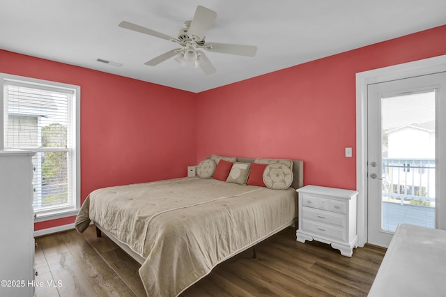 bedroom with access to exterior, a ceiling fan, visible vents, and wood finished floors