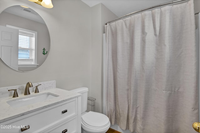 bathroom featuring visible vents, vanity, toilet, and a shower with curtain