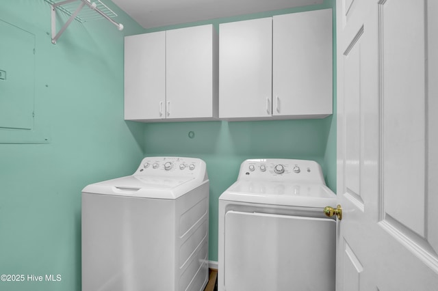 clothes washing area featuring cabinet space and washing machine and clothes dryer