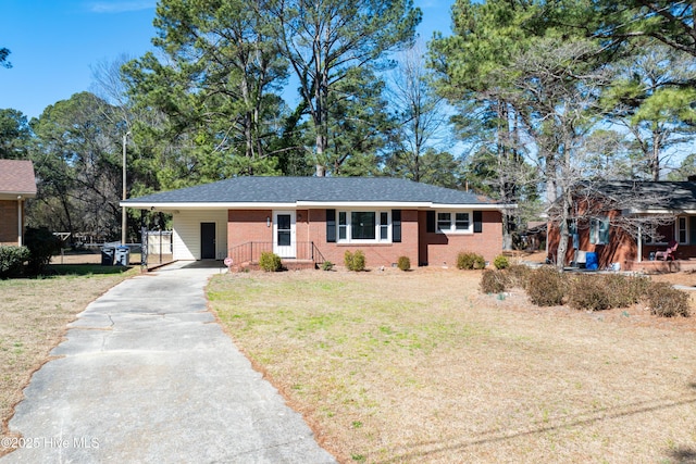 ranch-style house with driveway, brick siding, a front yard, and an attached carport